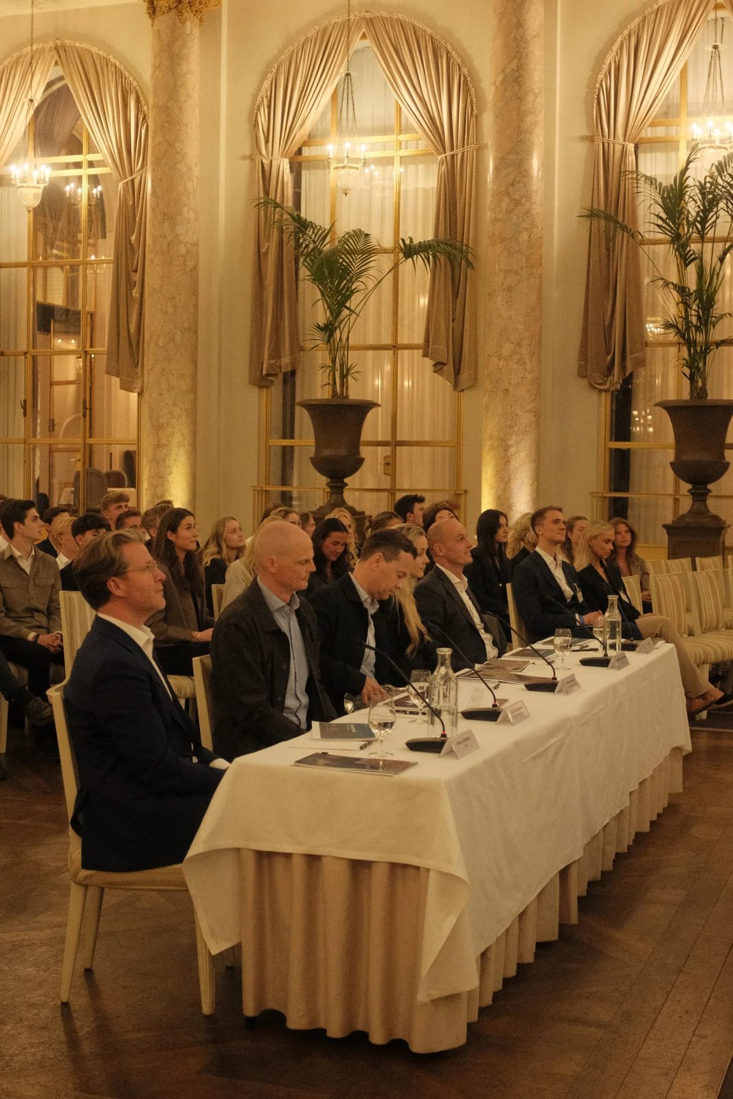 The jury panel and audience in the ballroom